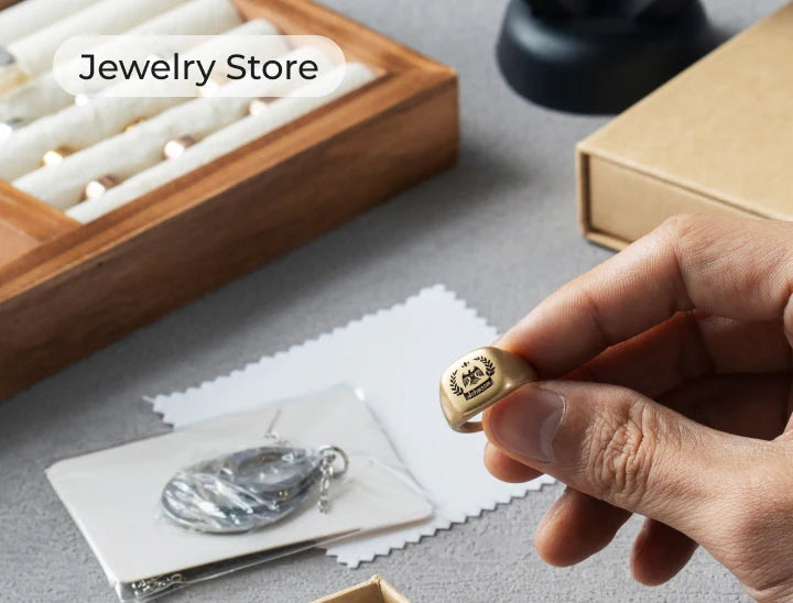 Hand holding a gold ring that customised with xTool F1 ultra laser engraver.