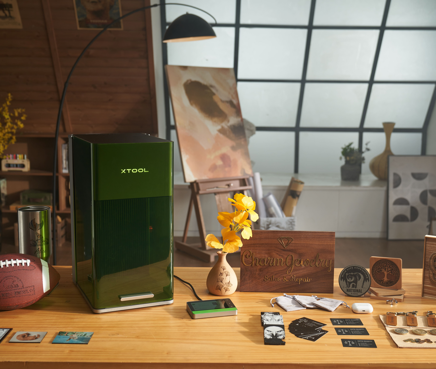 xTool F1 Ultra on a wooden table with decorative items in a room setting